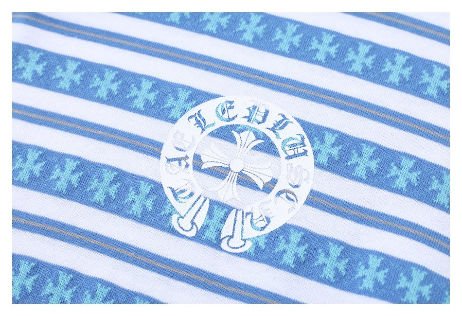Close-up of a circular white graphic on a blue-and-white striped shirt with snowflake-like bands.