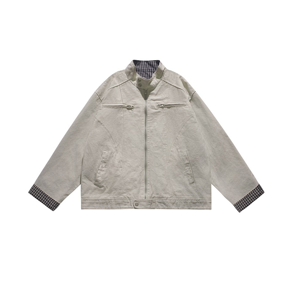 Beige stand-collar zip jacket with chest zip pockets and navy check cuffs and inner collar, front flat view