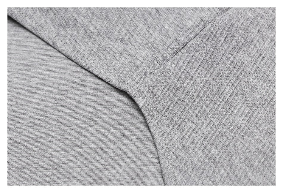 Close-up of heather-gray garment fabric and a curved stitched seam.