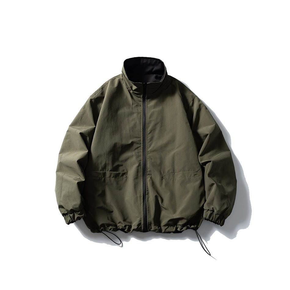 Olive green stand-collar zip jacket with drawstring hem and elastic cuffs, black inner collar, flat lay
