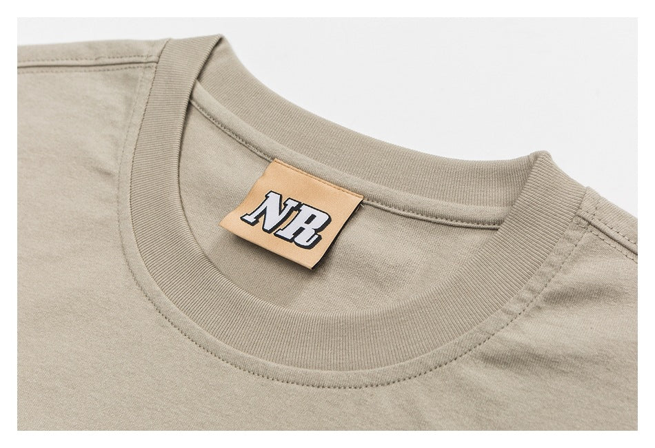 Close-up of a beige sleeveless shirt's ribbed crew neck and tan NB label.