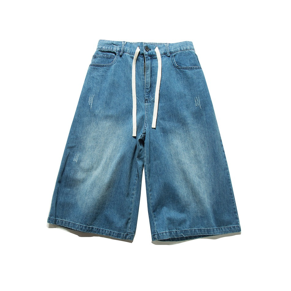 Blue washed denim wide-leg knee-length shorts with white drawstring, flat lay front view