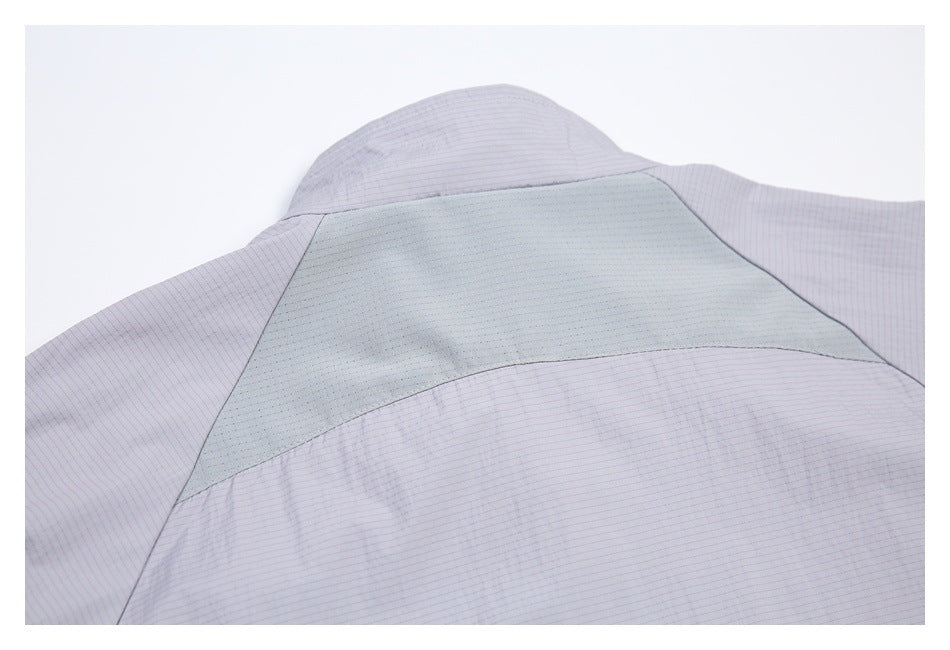 Close-up of the jacket's back yoke with a pale gray mesh ventilation panel.