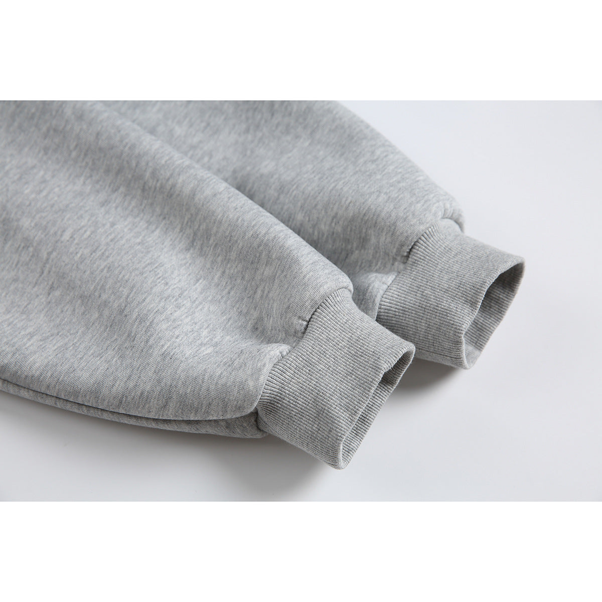 Close-up of the heather-gray jacket's sleeves and wide ribbed cuffs.