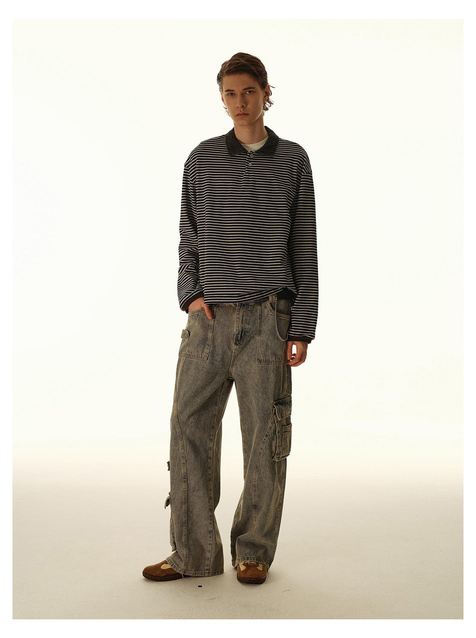 Front view of a model wearing a black-and-cream striped long-sleeve polo with loose gray cargo jeans.