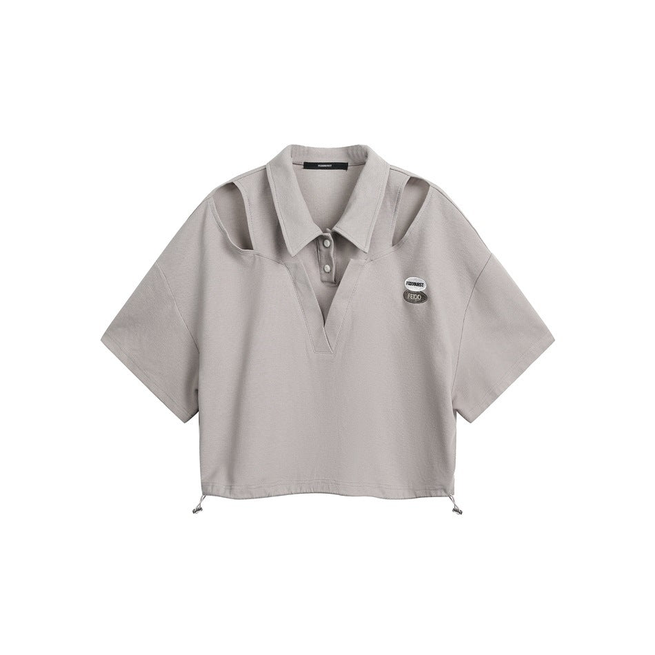 Front view of a light gray short-sleeve collared top with shoulder cutouts, a two-button placket, chest patches, and drawcord