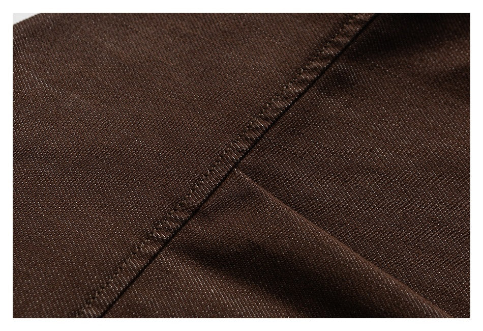 Close-up of dark brown fabric with a diagonal stitched seam.