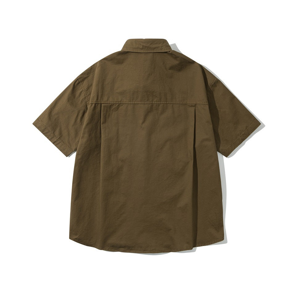 Back view of a dark olive short-sleeve button-up shirt with a yoke and box pleat.