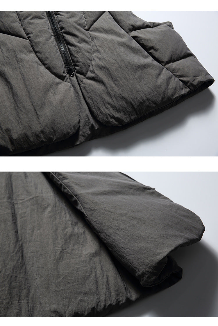 Two close-up views of a charcoal-gray padded vest showing the hem, zipper, and layered side construction.