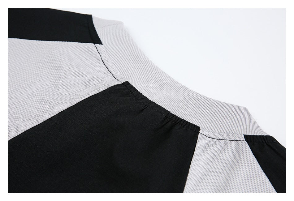 Close-up of a ribbed crew neckline and black-and-light-gray color-blocked panels.