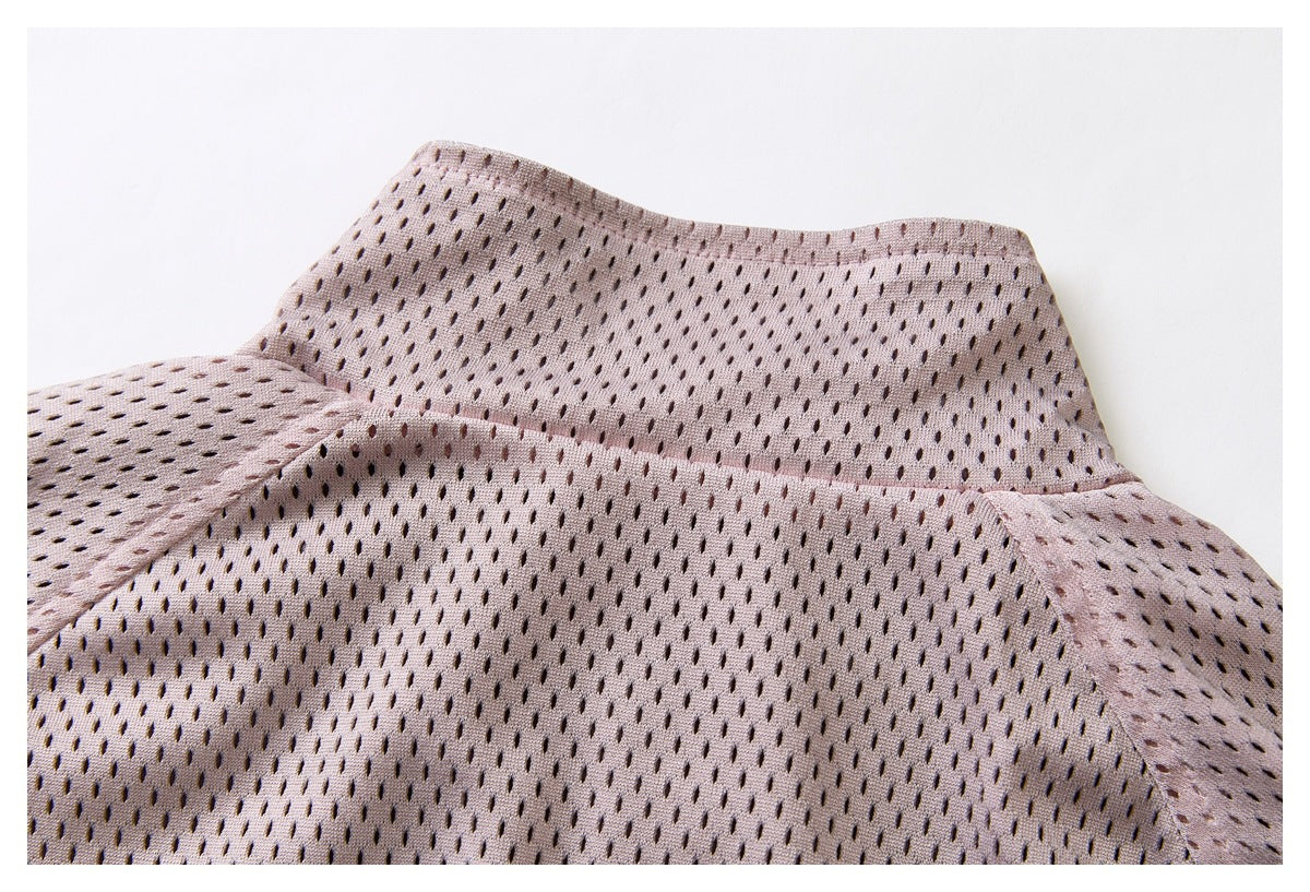 Close-up of the garment's back neckline, shoulder seams, and pale mauve perforated fabric.