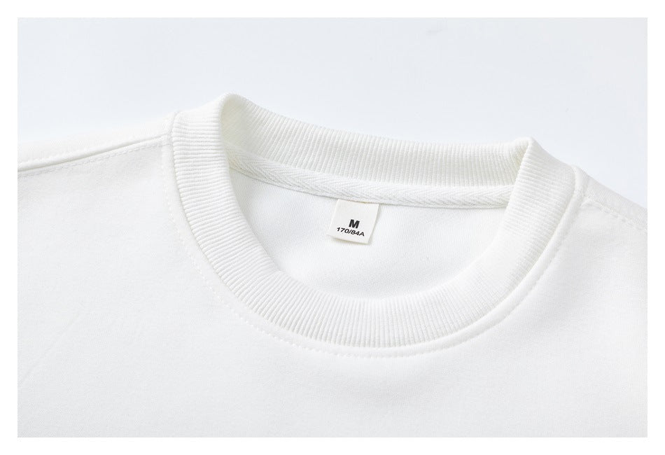 Close-up of a white sweatshirt's ribbed neckline and inner size label marked M.