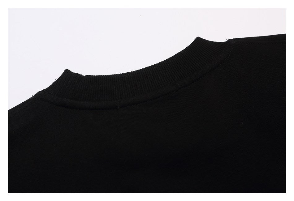 Close-up of the back neckline and ribbed crew collar of a black sweatshirt.