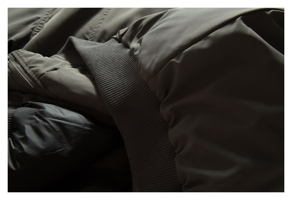 Close-up of a dark olive jacket sleeve and ribbed cuff.