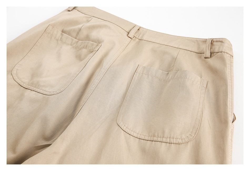 Partial rear view of beige trousers with two patch pockets and belt loops.