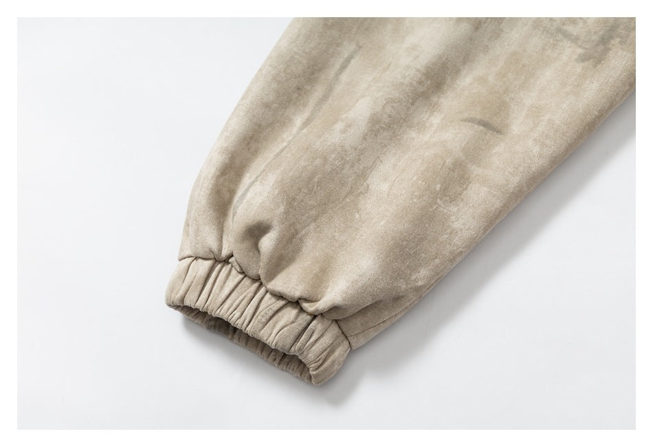 Close-up of the beige mottled jacket sleeve ending in a gathered elastic cuff.