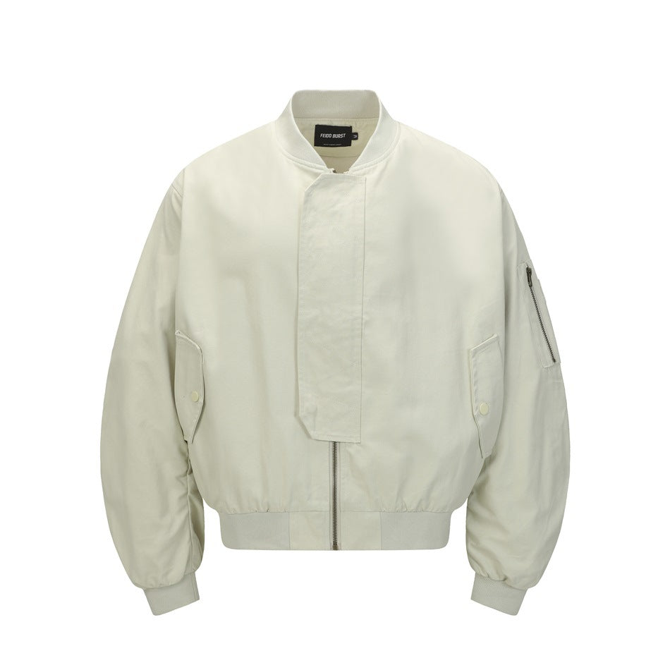 Ivory bomber jacket with a snap-covered front zipper, flap pockets, and a zippered sleeve pocket.