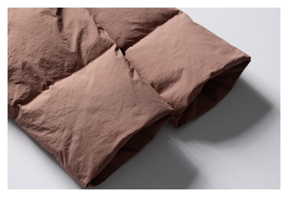 Close-up of the dusty rose jacket's folded cuff or hem and stitched edge.
