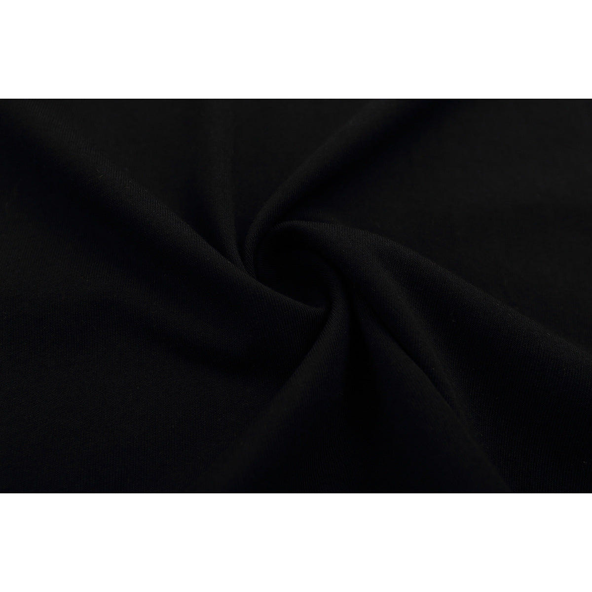 Close-up of black fabric gathered into folds, showing its fine surface texture.