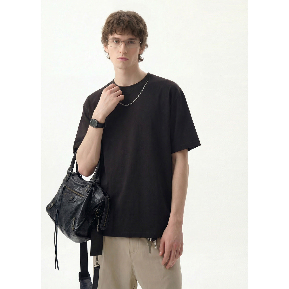 Model wearing a plain black crew-neck T-shirt, shown from the front.