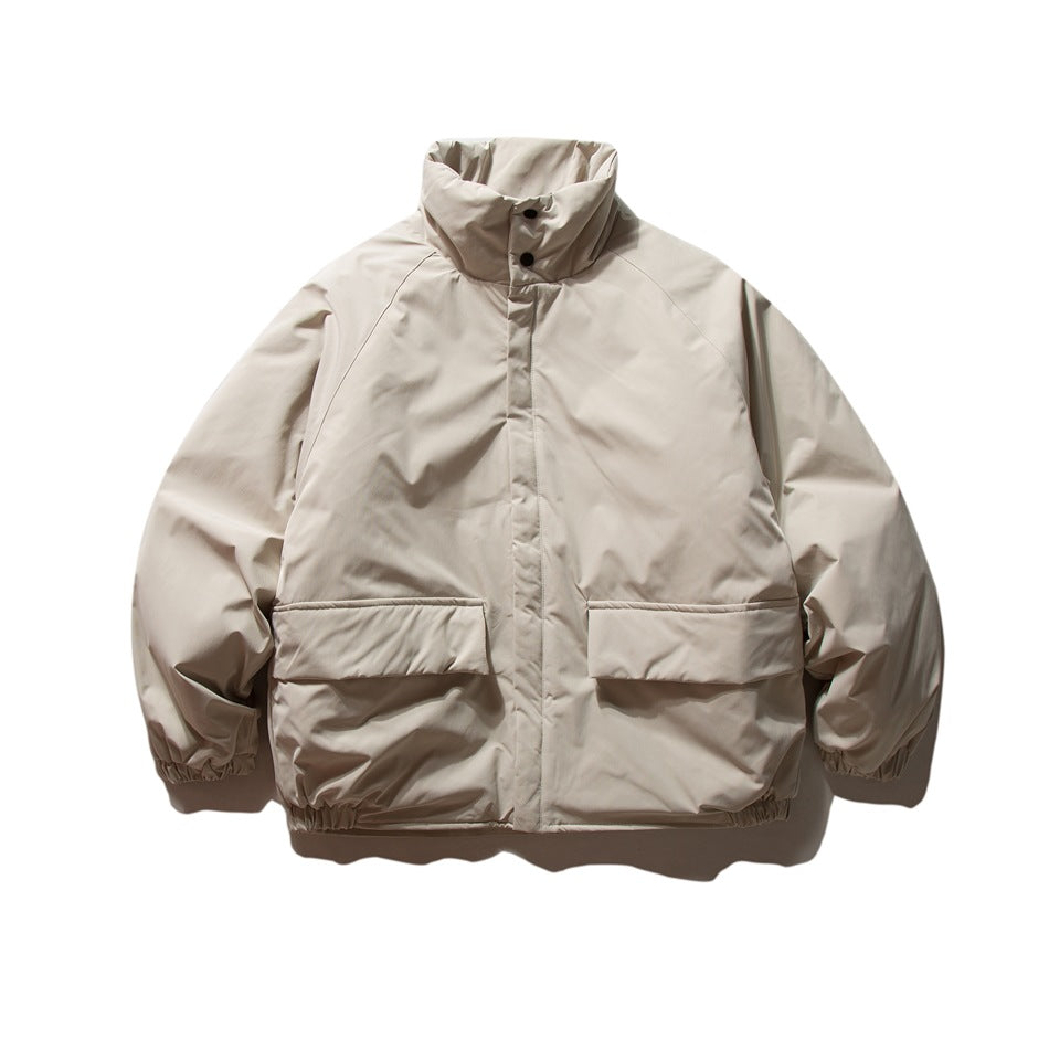 Beige oversized stand-collar puffy jacket with two flap pockets and elastic cuffs, front flat view