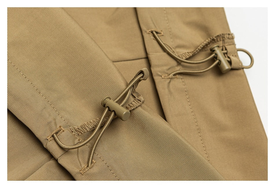 Close-up of tan garment with adjustable elastic drawcords and cord locks.