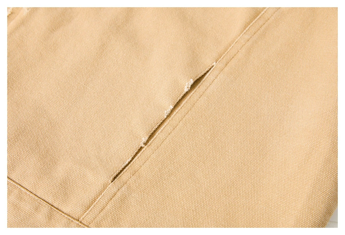 Close-up of a diagonal seam opening on tan woven fabric.