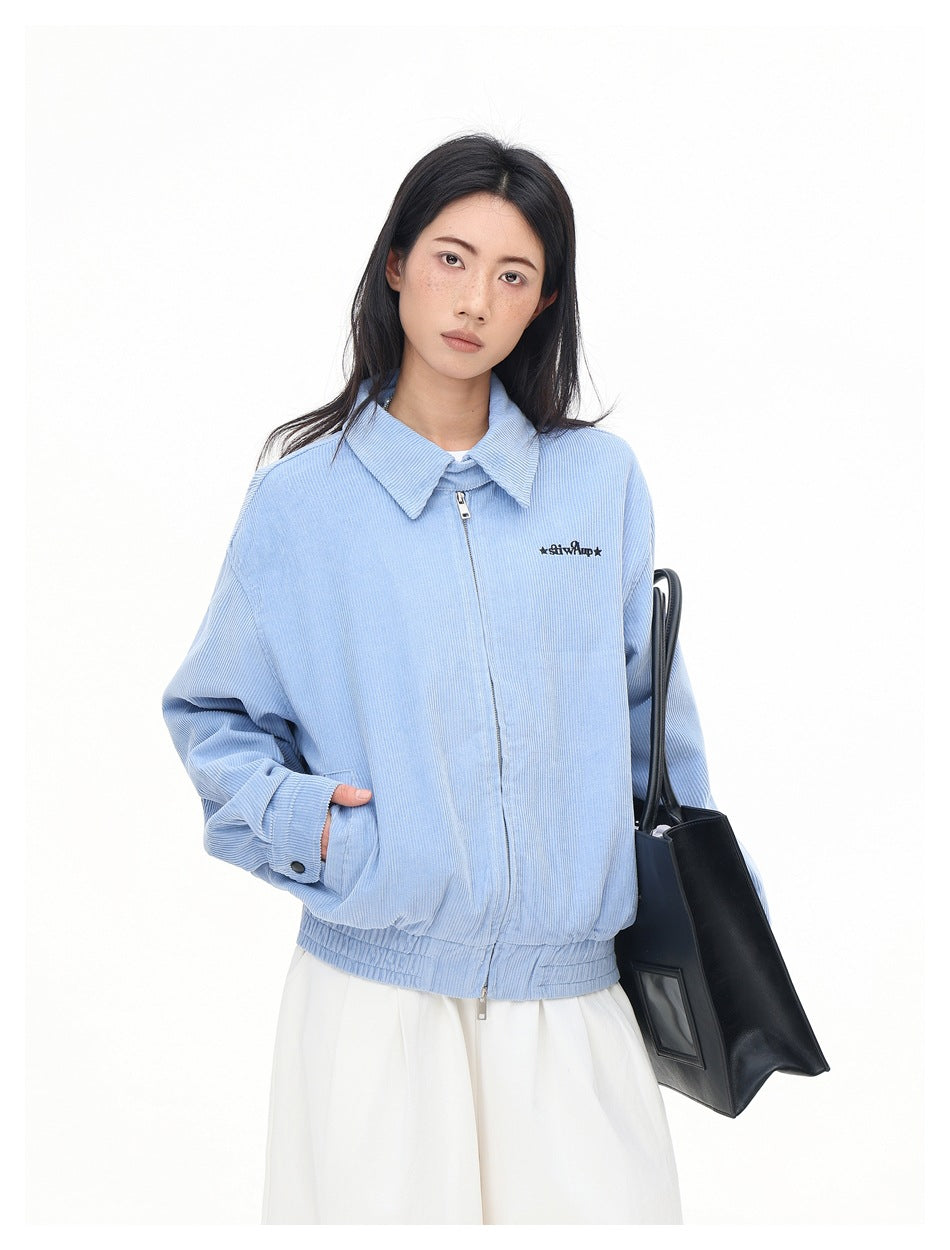 Model wearing a light blue collared zip jacket with elastic cuffs and hem, shown at a slight angle.