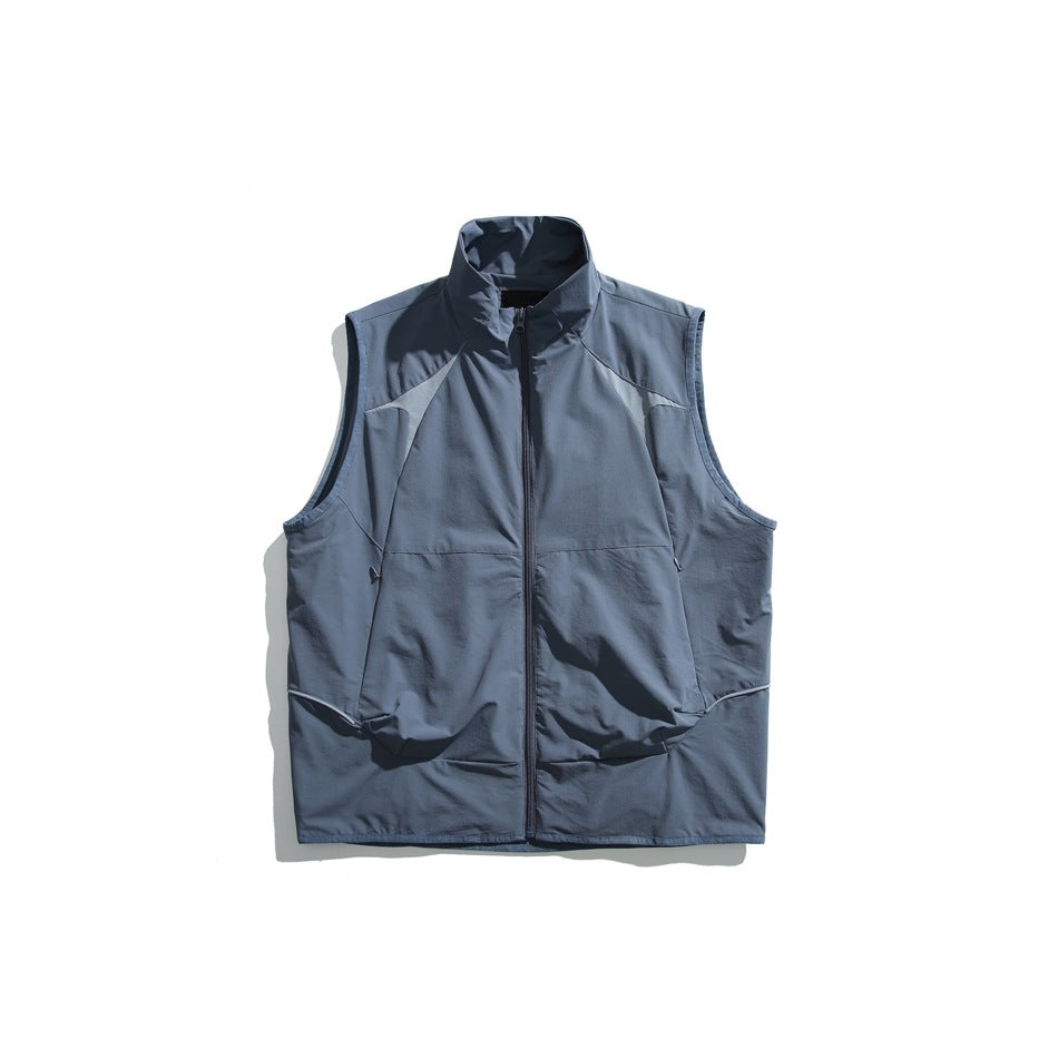 Blue zip-front stand-collar vest with lighter blue contrast shoulder panels, flat lay on white background