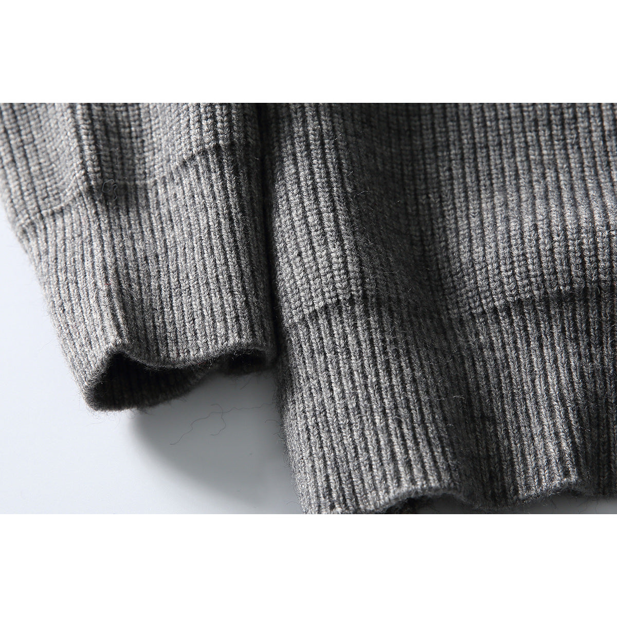 Close-up of the gray cardigan's ribbed sleeve cuff and hem.