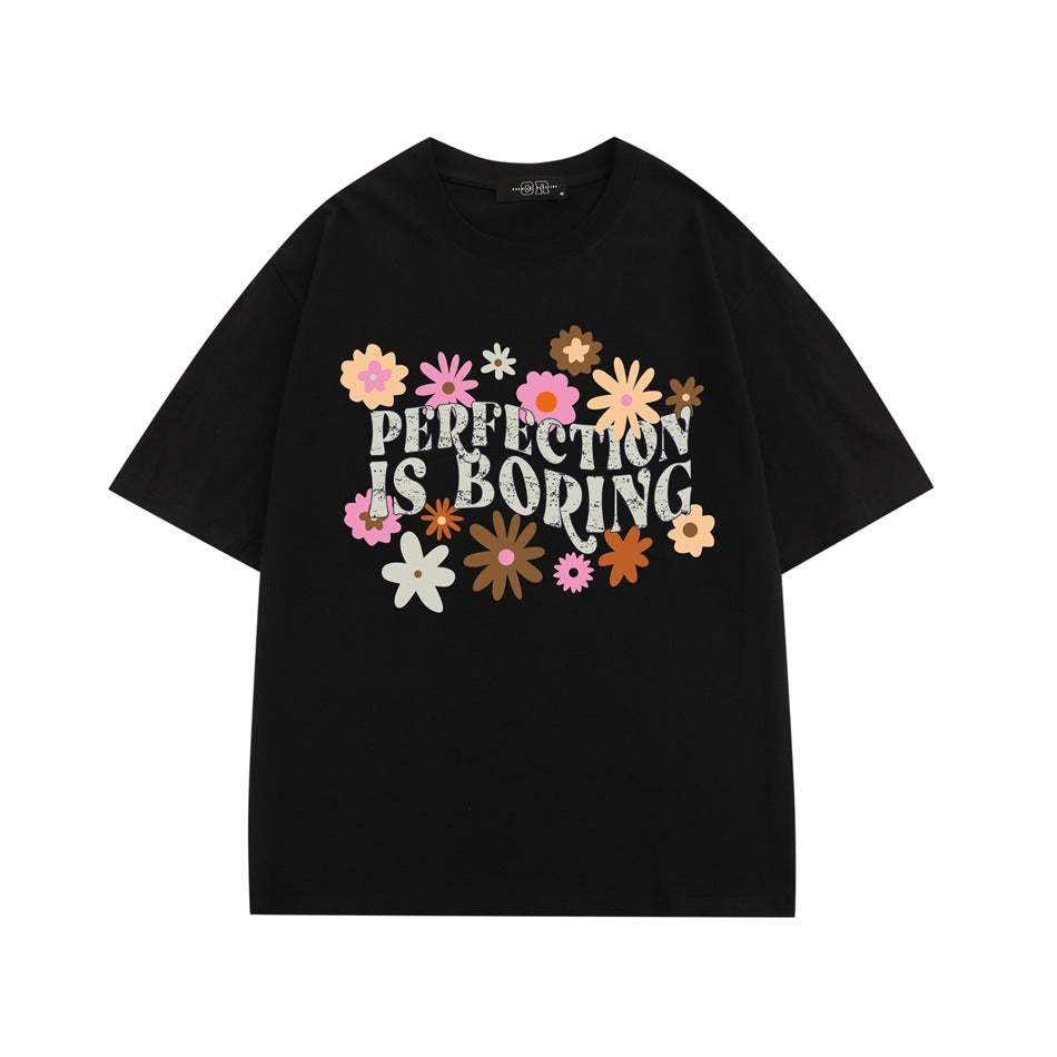 Black short-sleeve crew neck T-shirt with colorful retro flowers and 'PERFECTION IS BORING' print