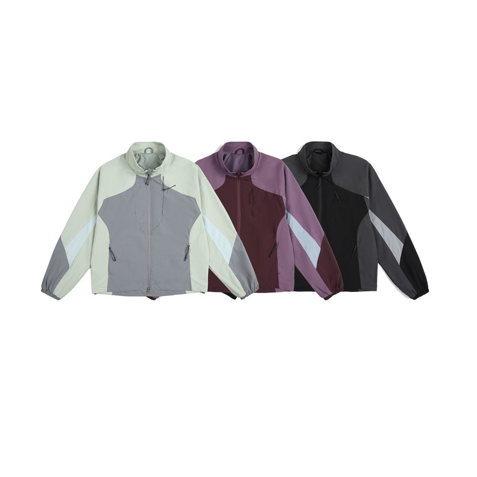 Three front views of the color-block zip jacket in pale mint and gray, plum and lilac, and charcoal and black.