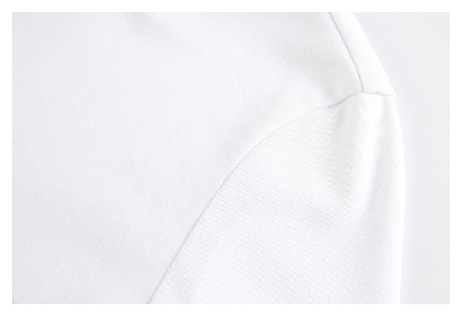 Close-up of the shoulder and sleeve seam on a white shirt.