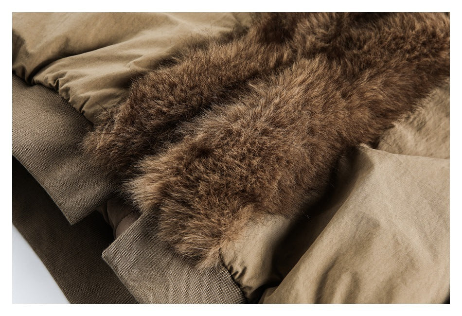 Close-up of the plush brown collar, tan jacket fabric, and ribbed cuff.