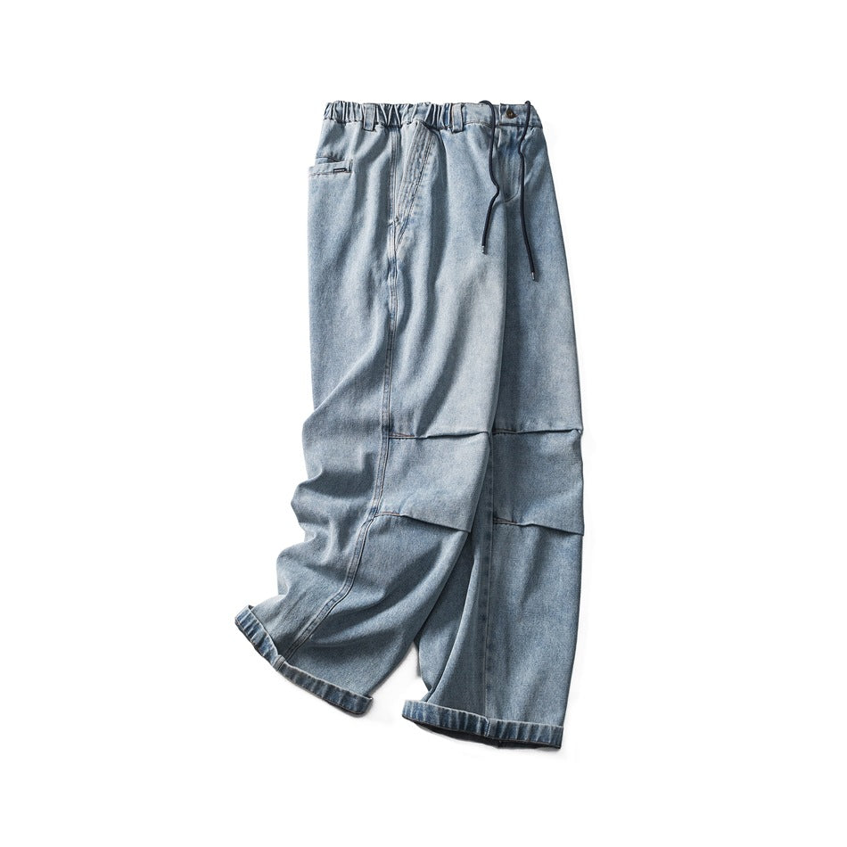 Angled view of light blue wide-leg jeans with an elastic waist and dark drawstrings.