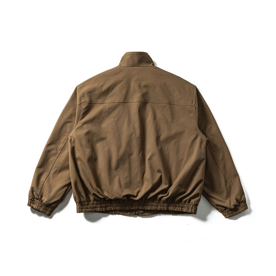 Back view of brown khaki stand-collar jacket flat lay showing yoke seam and elastic cuffs and hem