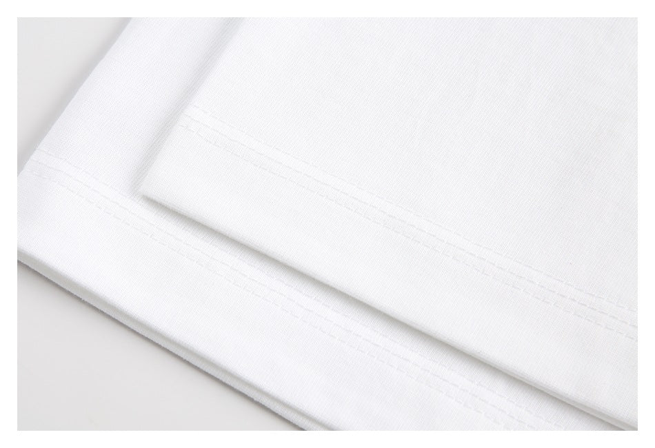 Close-up of a white T-shirt hem with parallel rows of stitching.