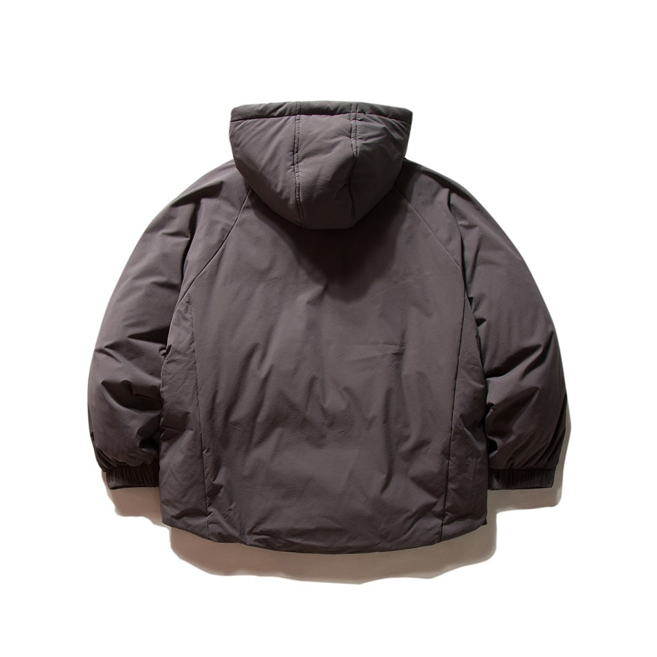 Back view of dark gray hooded quilted jacket with raglan sleeves and ribbed cuffs, laid flat