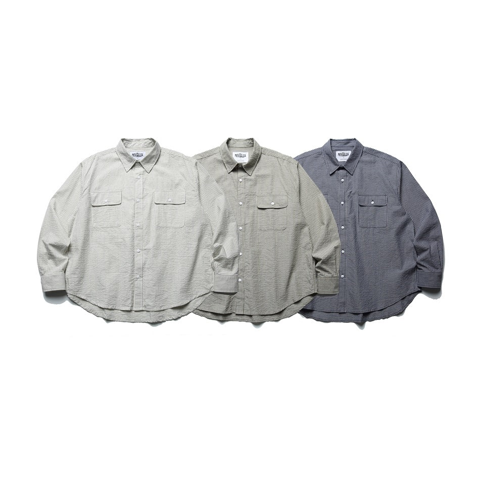 Three long-sleeve button-up shirts with pointed collars and chest pockets in light, gray-beige and dark blue-gray colors.