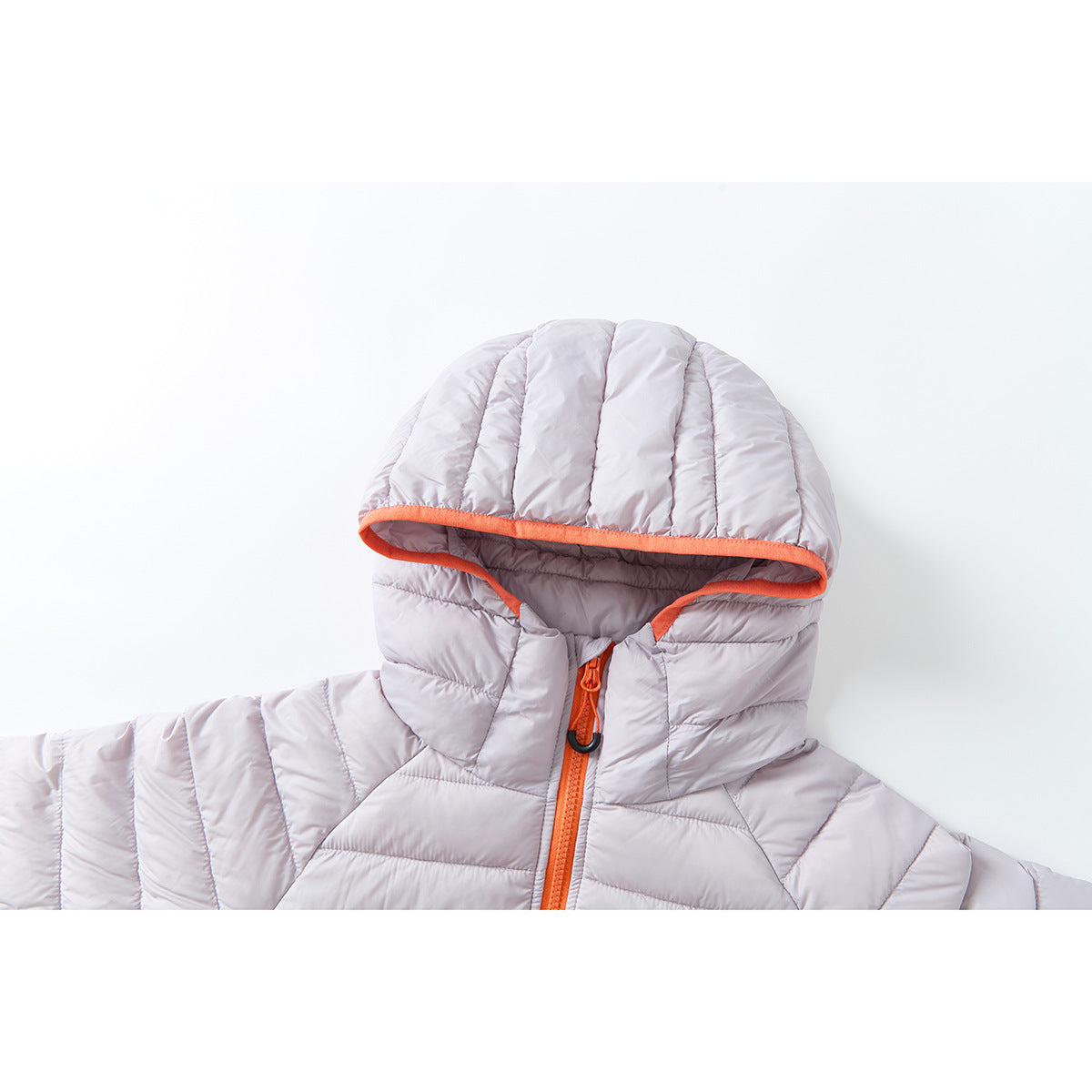 Close-up of a pale lavender quilted jacket hood with bright orange trim and a matching front zipper.