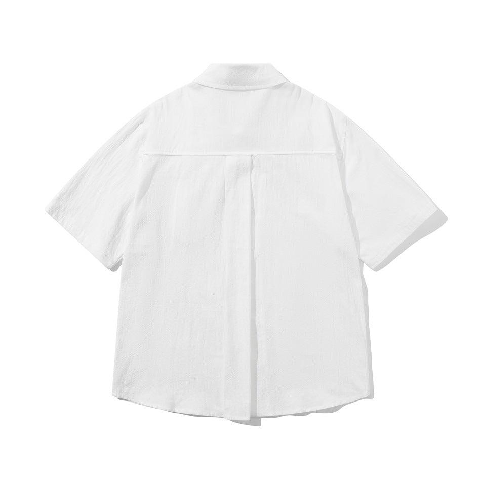 Back view of a white short-sleeve button-up shirt with a center pleat and curved hem.