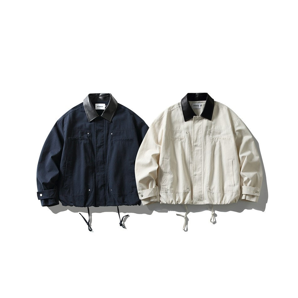 Two front-facing utility jackets, one navy and one off-white, both with black collars, flap chest pockets, and drawstring