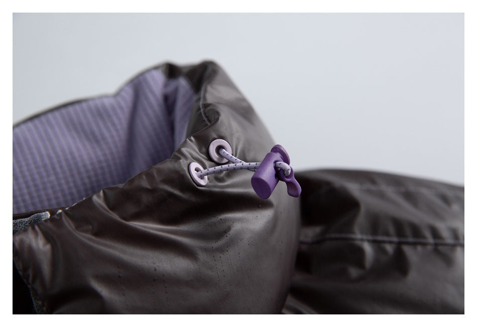 Close-up of a dark jacket collar with lavender lining and an adjustable drawcord toggle.