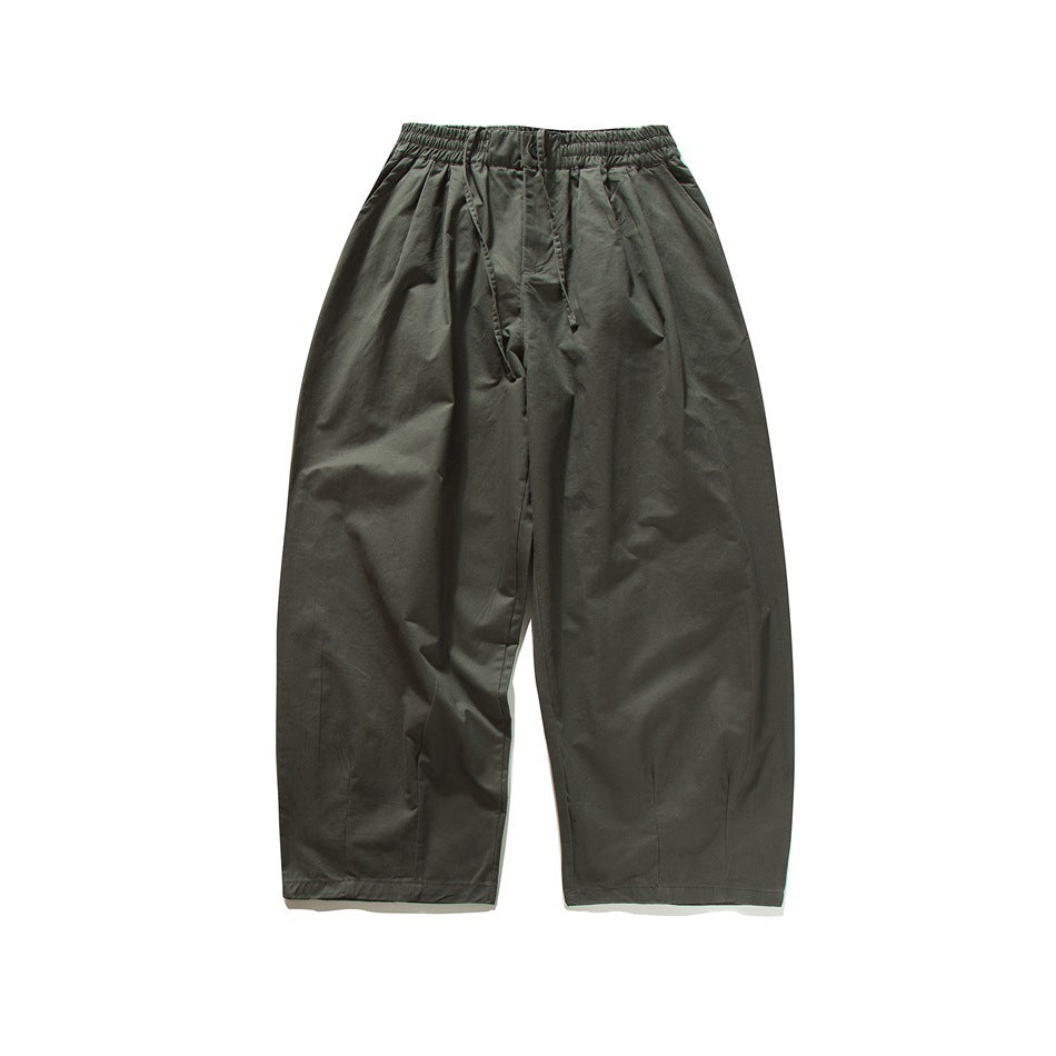 Dark gray wide-leg pants with elastic drawstring waist, front pleats and side pockets, flat lay front view