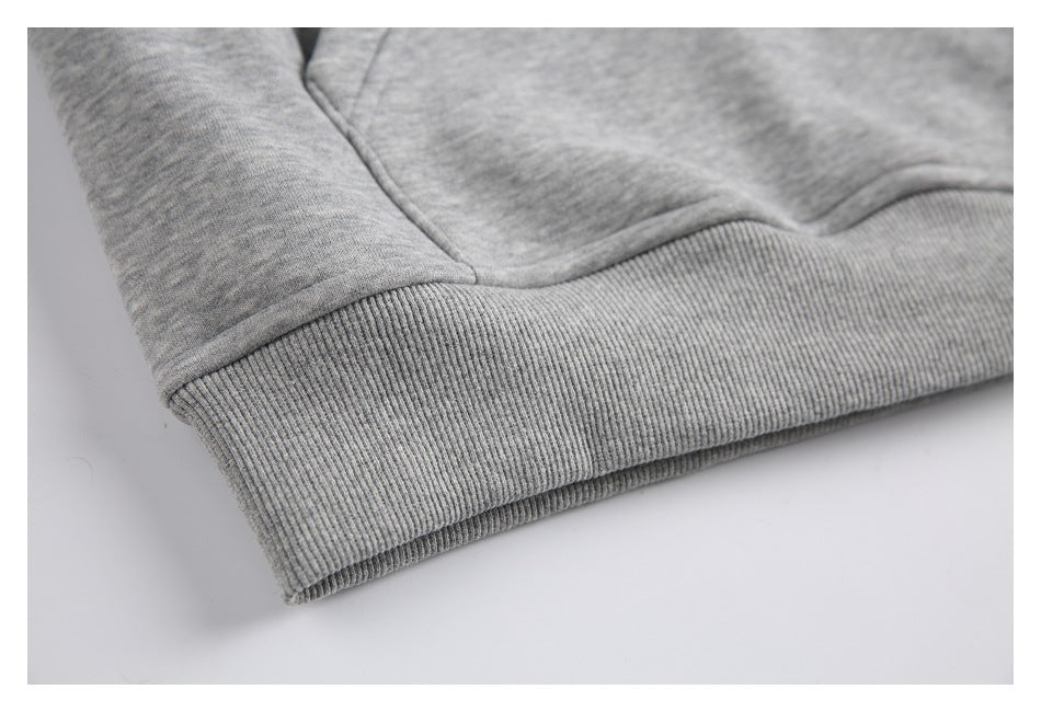 Close-up of a heather-gray sweatshirt's wide ribbed hem and seam.