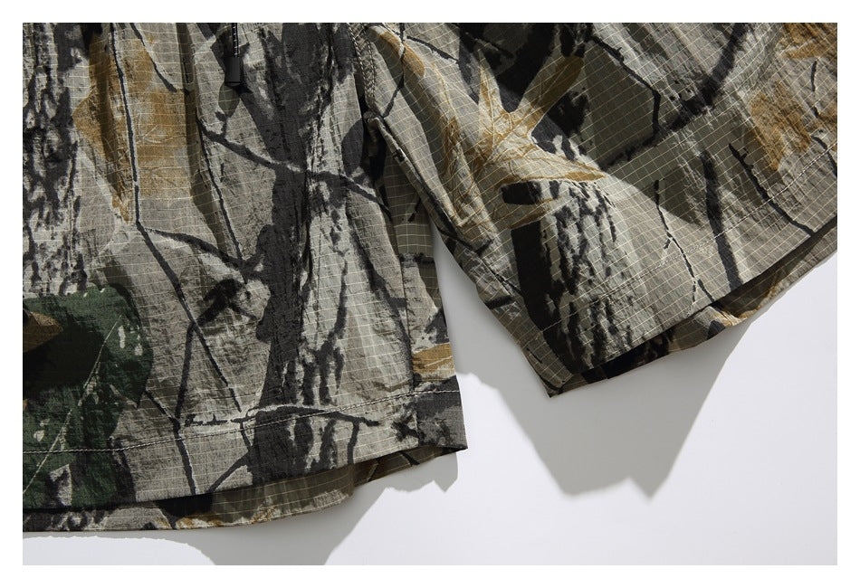 Close-up of the camouflage shorts' leg panels and stitched hems.