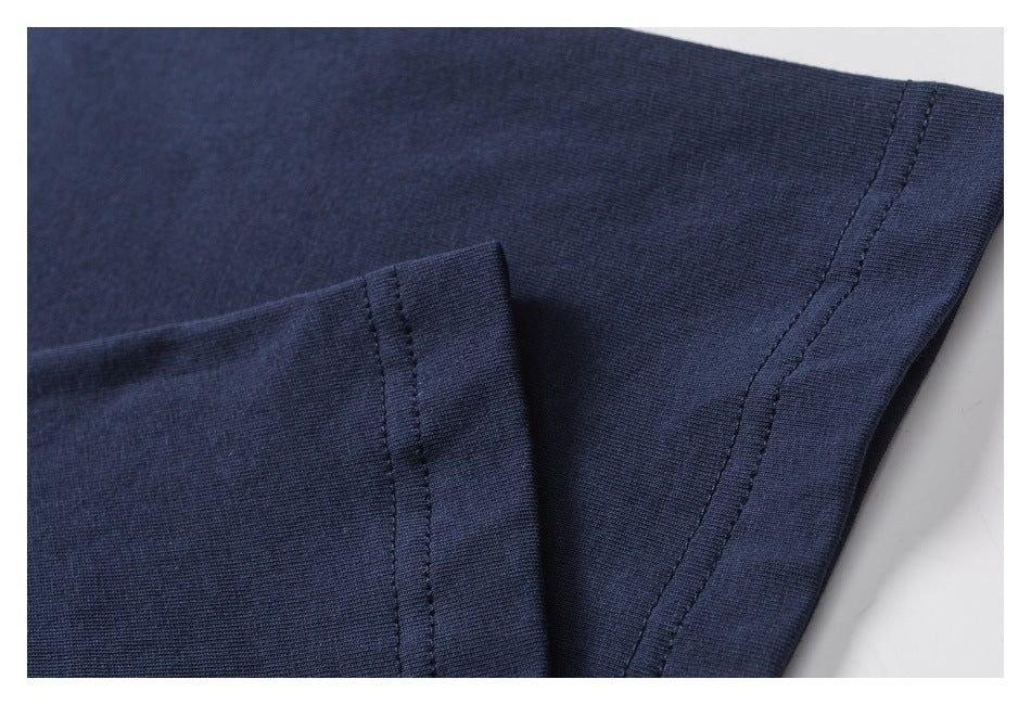 Close-up of a navy garment hem with visible double stitching and folded fabric.