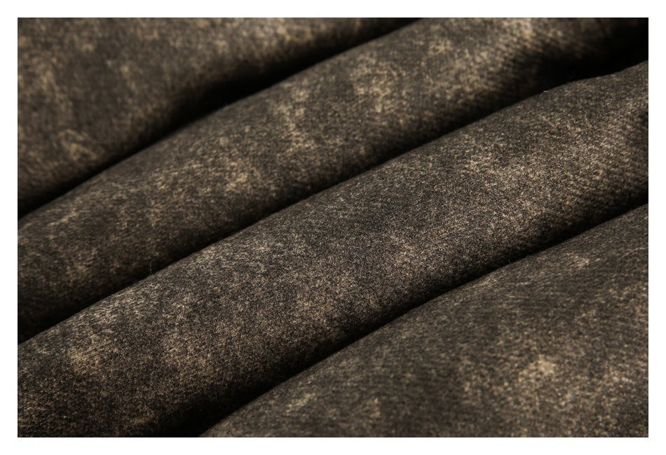 Close-up of the jacket's mottled brown fabric arranged in soft folds.