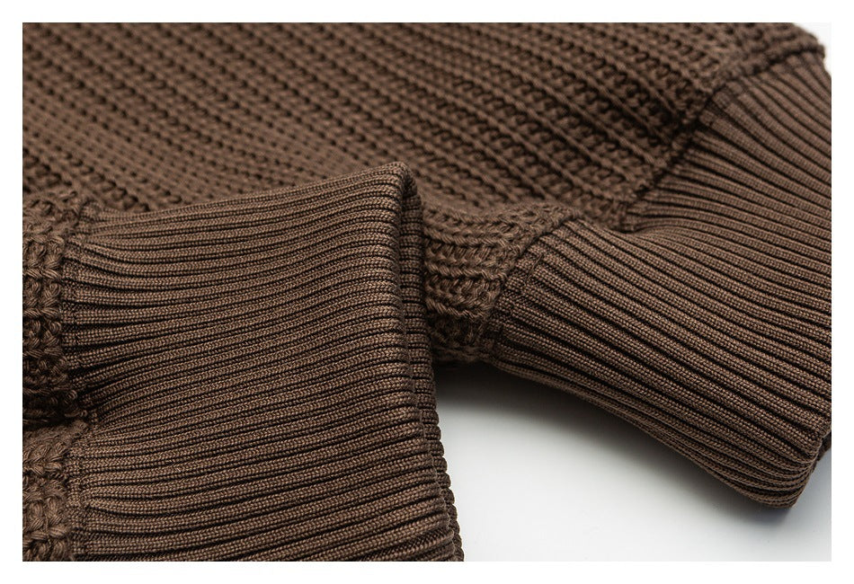 Close-up of the brown sweater's ribbed cuffs and textured knit sleeves.