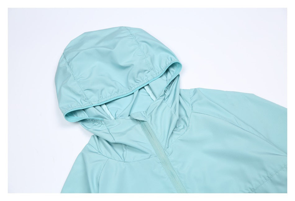Close-up of a light aqua jacket's hood, neckline, and front zipper on a white background.
